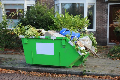 Worker wearing PPE while handling office waste items